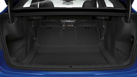 BMW 3 Series Sedan, trough-loading system. Close-up of the opened trunk with the rear backseats half folded down.