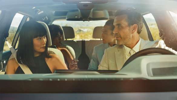 BMW X7 M Automobile with BMW Gesture Control BMW X7 M Automobile, Man and woman are sitting in the car, woman is applying the gesture control
