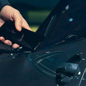 Digital Key Digital Key: Man holding his smartphone to the vehicle door from the outside