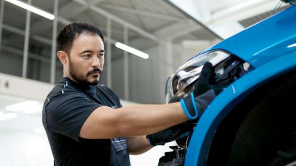 BMW specialist is polishing car BMW Repair & Care BMW specialist is polishing car