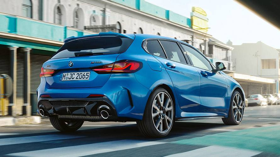 BMW 1 Series F40, three-quarter rear view driving BMW 1 Series F40 in Misano Blue metallic, three-quarter rear view driving