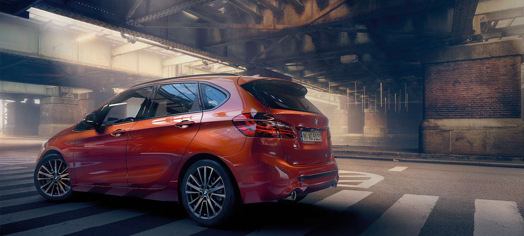 Side view BMW 2 Series Active Tourer BMW 2 Series Active Tourer F45 Sunset Orange metallic side view standing in hall