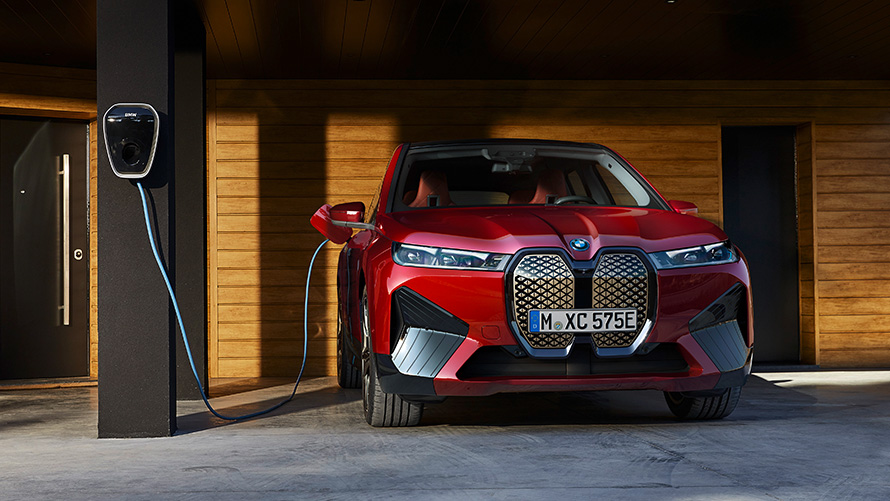 BMW iX i20 electric SUV charging BMW iX i20 2021 electric SUV Aventurin Red charging with a BMW Wallbox charging