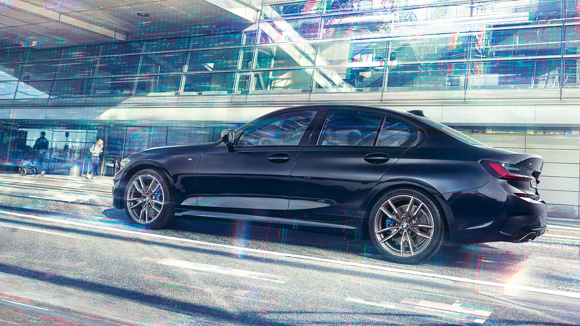 Side view BMW M340i xDrive Sedan BMW M340i xDrive Sedan G20 Sapphire Black metallic side view while driving