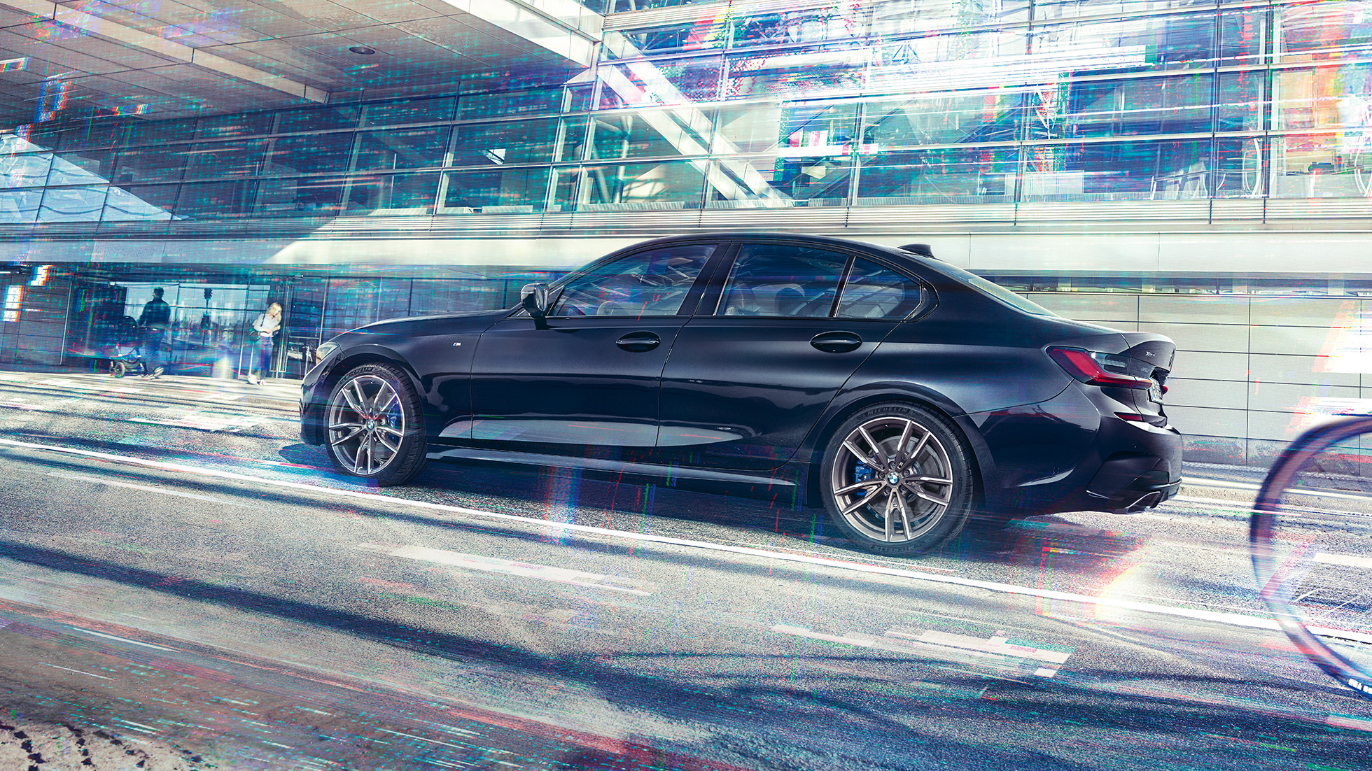 Side view BMW M340i xDrive Sedan BMW M340i xDrive Sedan G20 Sapphire Black metallic side view while driving
