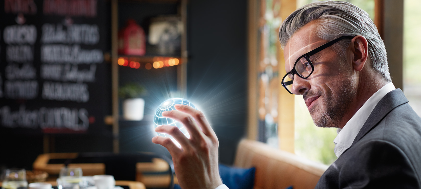 BMW ConnectedDrive Digital Services Man holds ConnectedDrive globe in his hands and is fascinated.