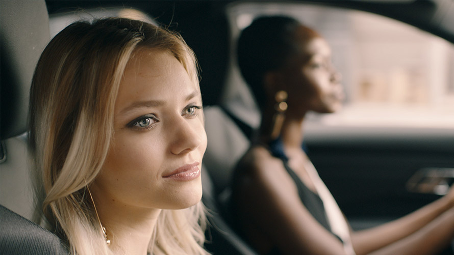 BMW Intelligent Personal Assistant, In-Car Experiences Two women driving in BMW and are using In-Car Experiences