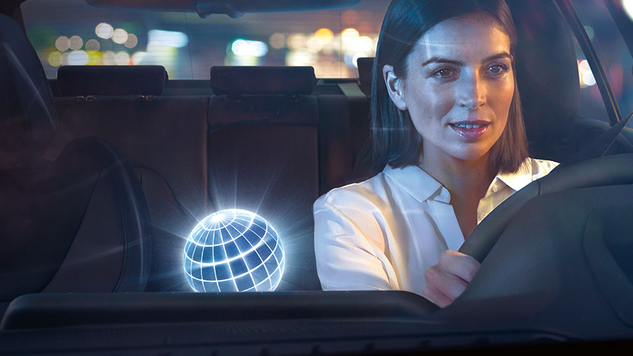 BMW Intelligent Personal Assistant Woman driving in BMW in nocturnal setting