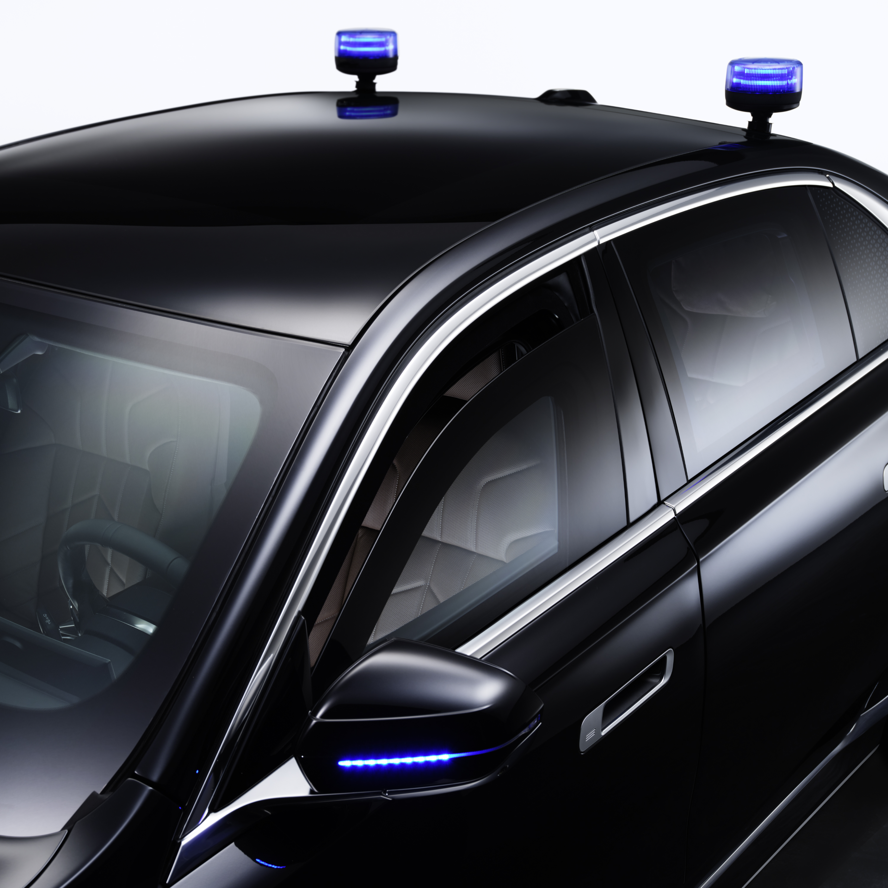 A BMW with close-up of flashing lights on the roof