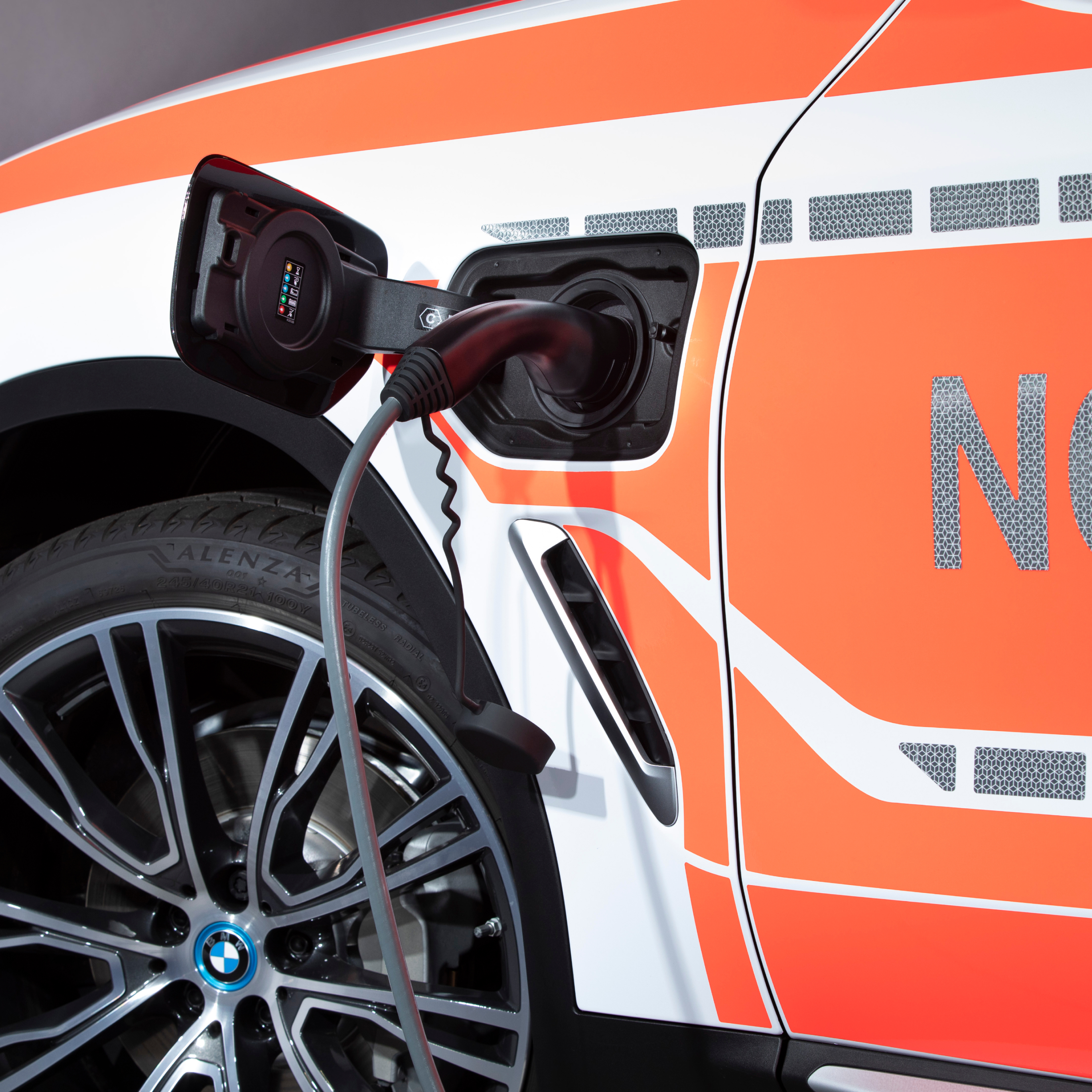 A BMW plug-in hybrid Authority Vehicle being charged; close-up of charging cable