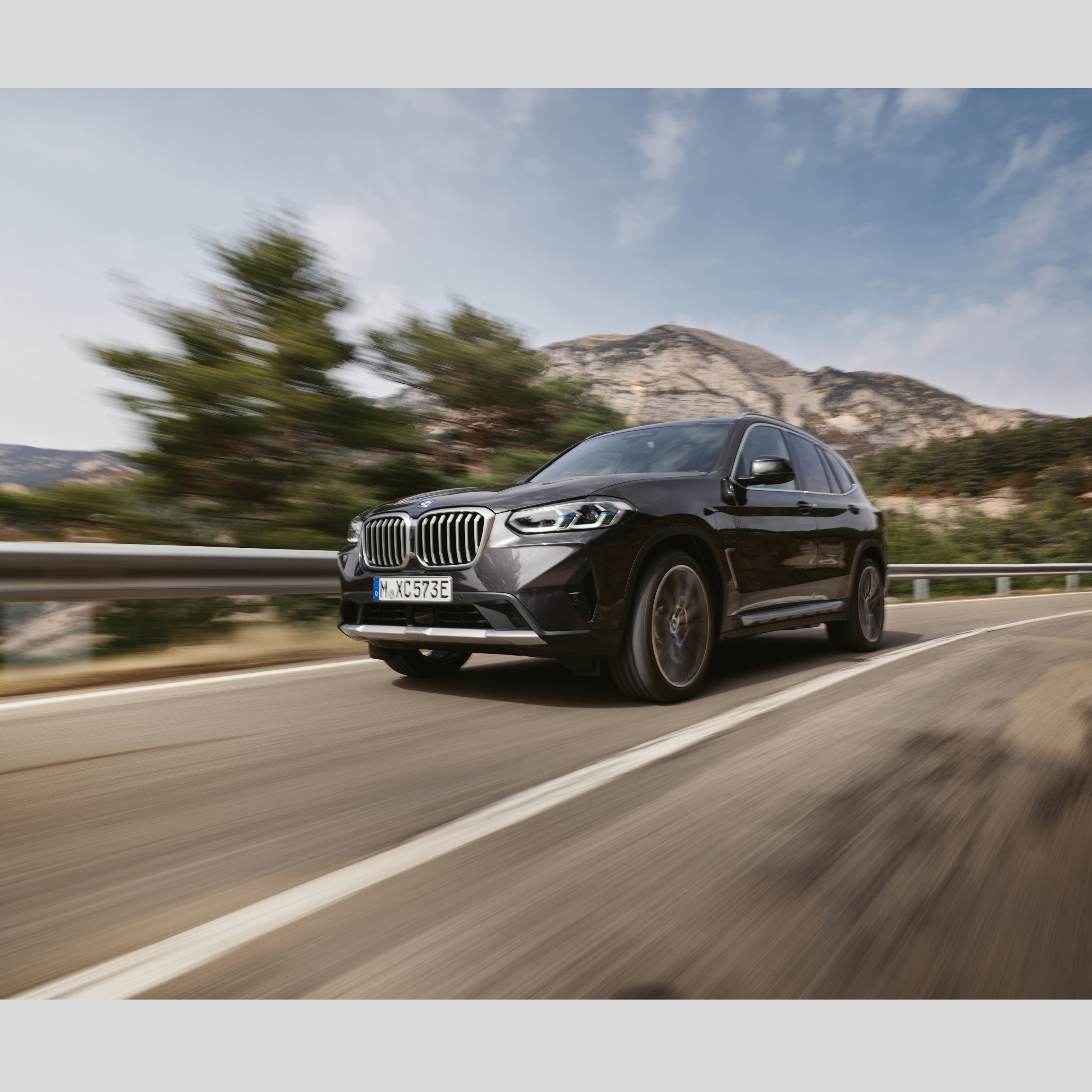 A BMW emergency vehicle is driving on a road